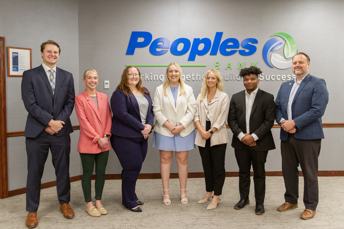 Six PDA graduates with Peoples Bank's CEO